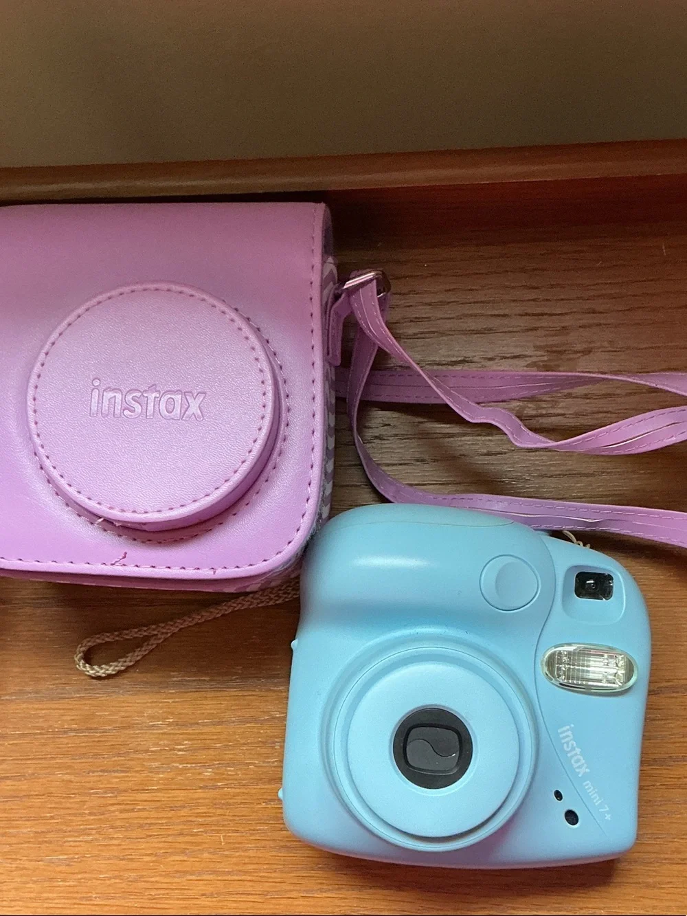 Instax Mini instant camera in light blue with pink carrying case